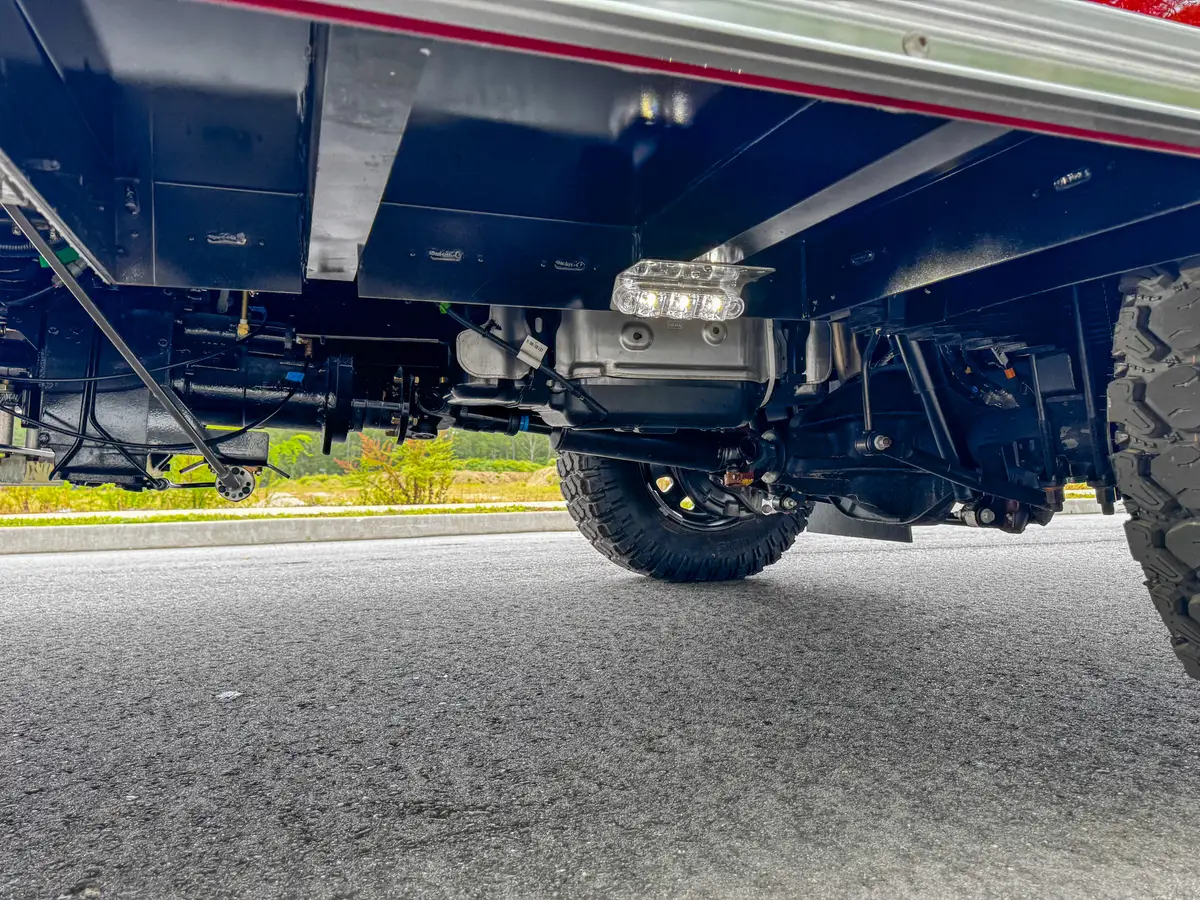 Undercarriage low-angle view showing rear axle and frame beneath the truck.